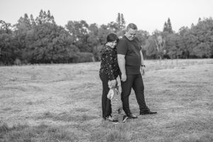 Family walking together in a park during a casual photo session.