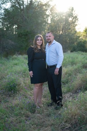 Romantic outdoor portrait in natural setting during golden hour.
