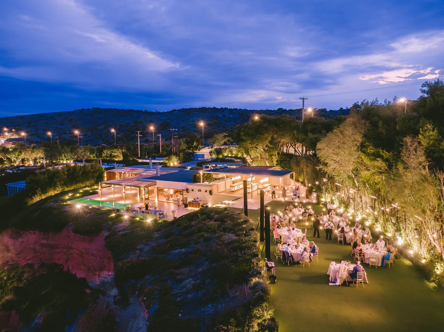 Aerial view of an elegant outdoor wedding evening event in Athens Island Riviera Captured by GeorgeNafpliotis.com