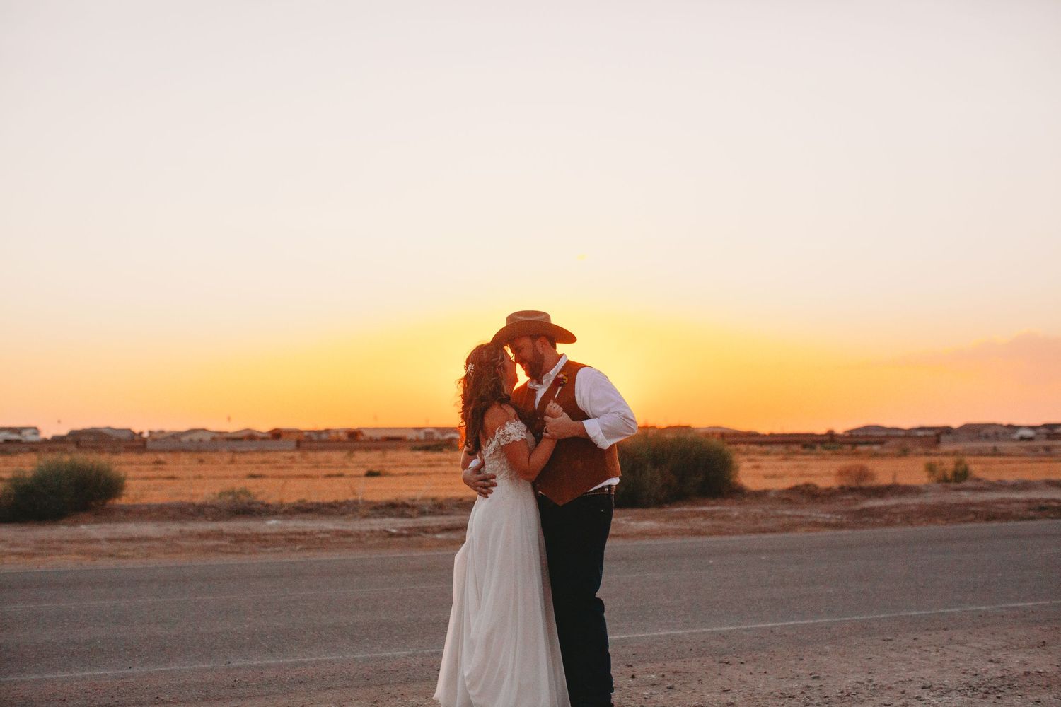 Romantic desert engagement photos at sunset with mountains in background.