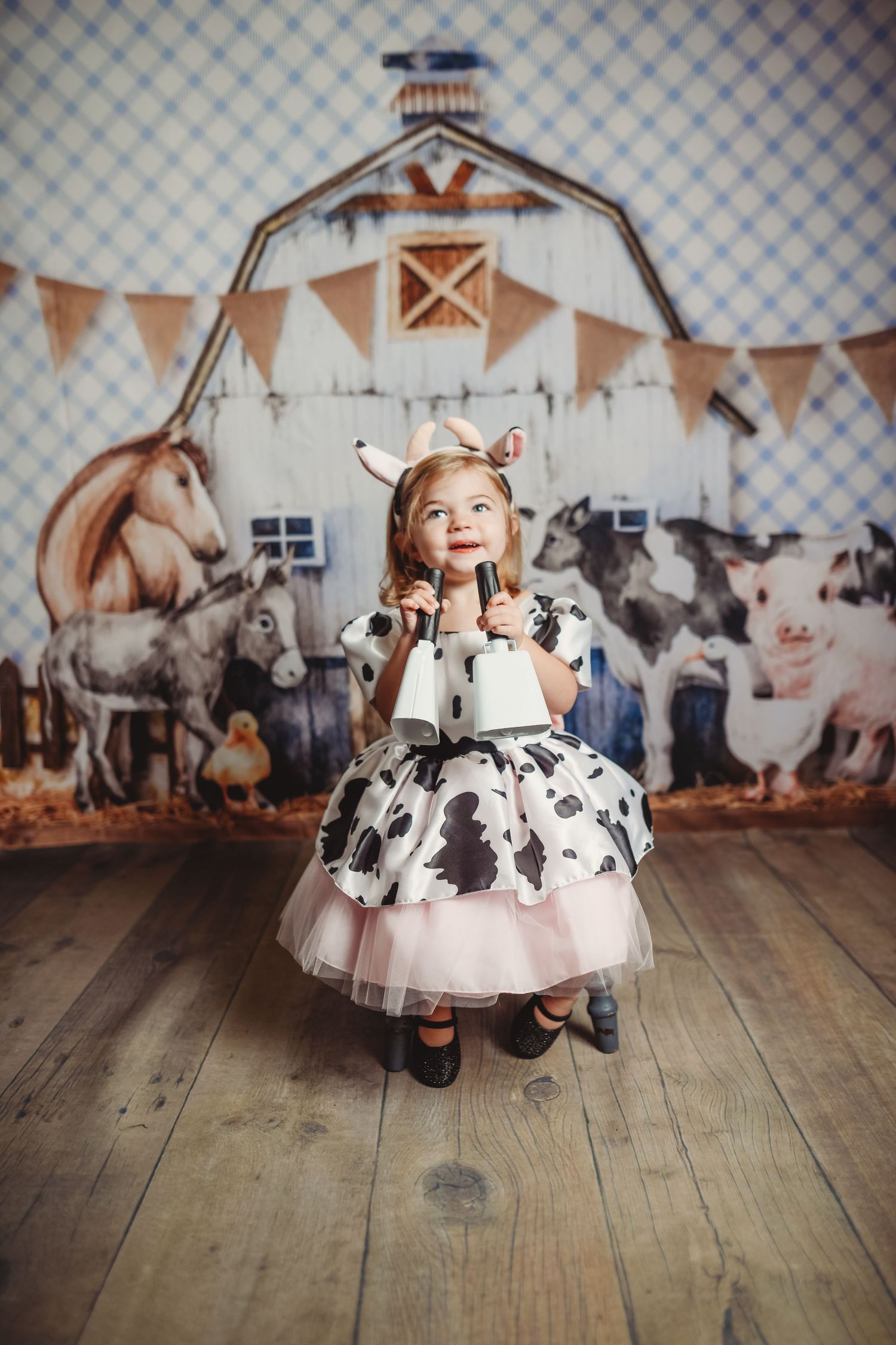 A sequence of playful photos showing a child in a polka dot dress twirling on a wooden floor.