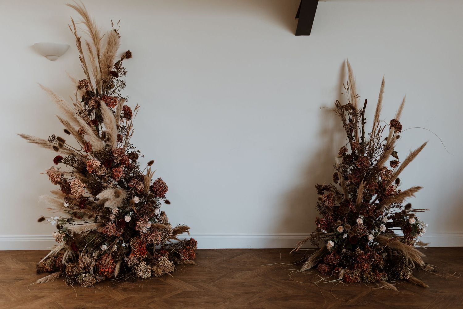 False and silk large floral pillars for winter wedding at Malt House Barn's Shrewsbury