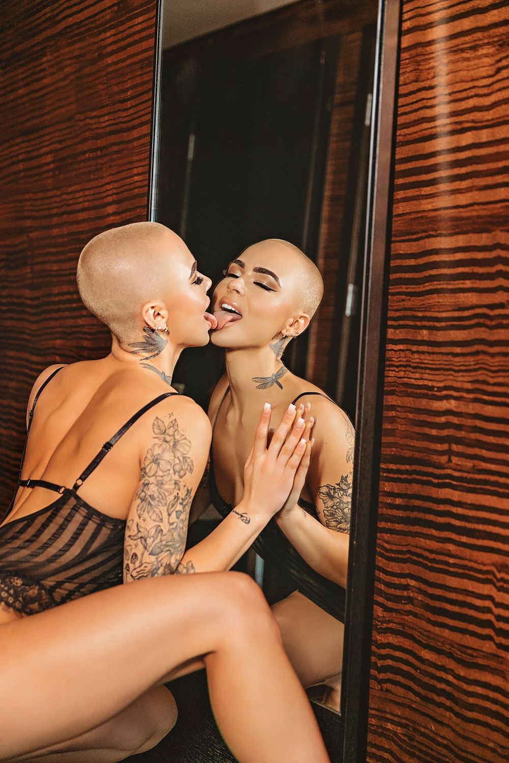 Intimate artistic portrait of two people reflected in mirror.