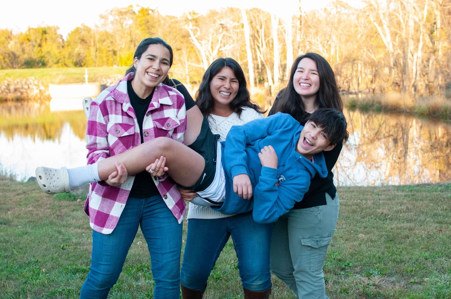 Adult sisters holding brother
