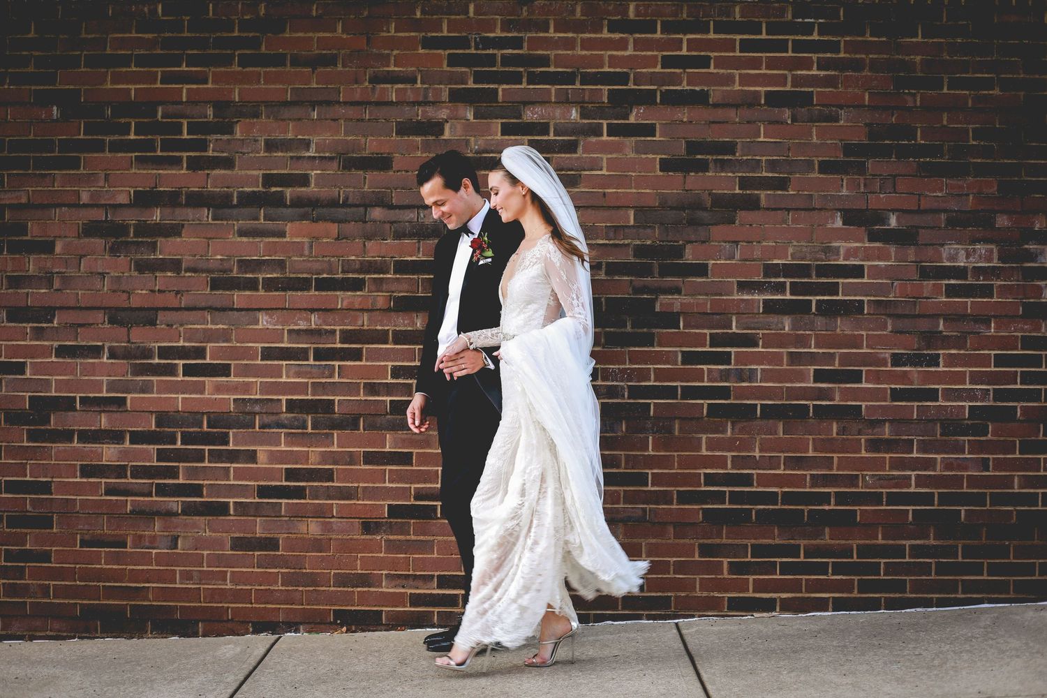 Newlywed couple walking in Pack Square Asheville NC