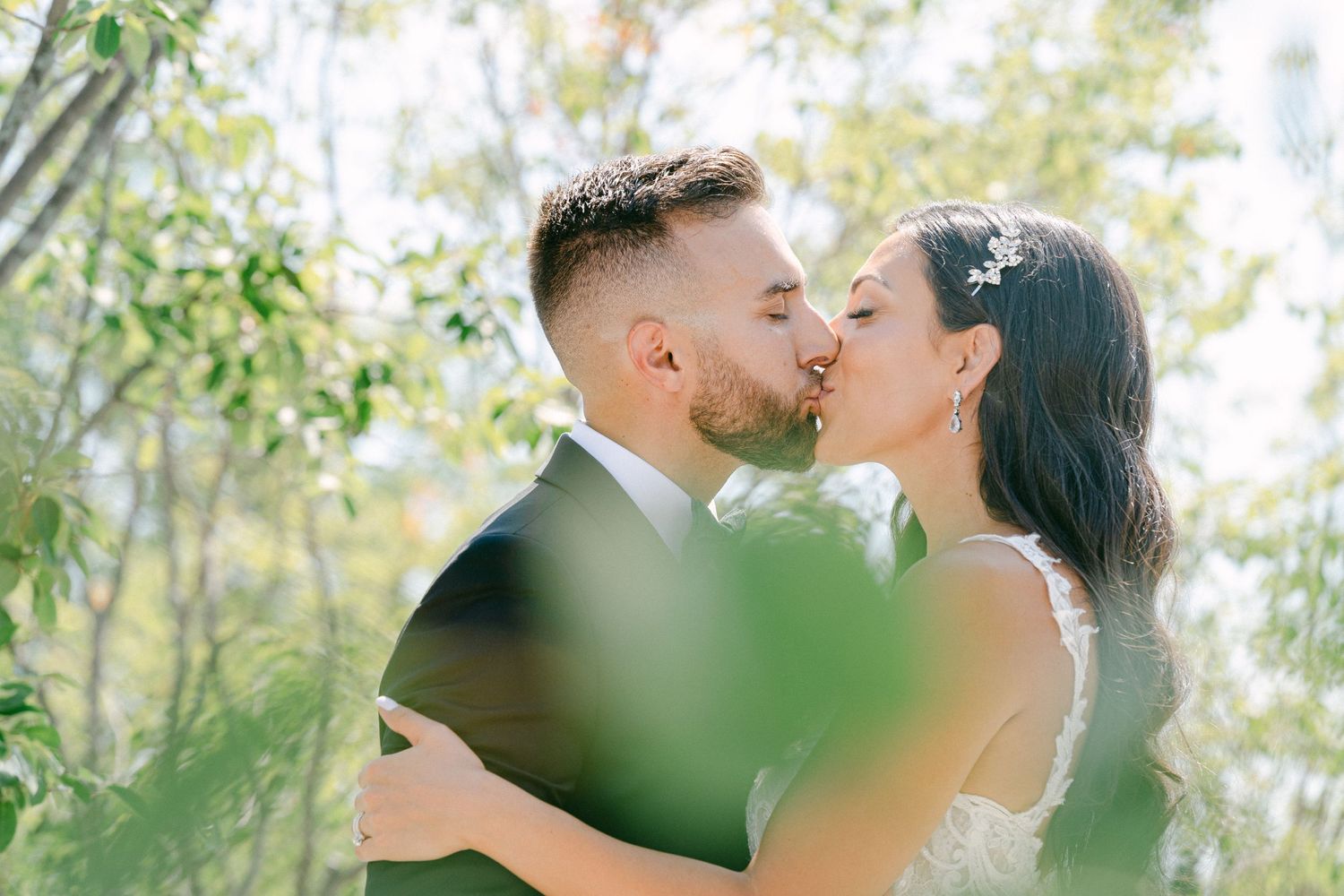 Bride and Groom Kissing Among Trees in Toronto