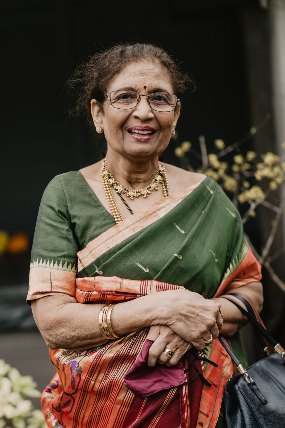 The Mother of the Bride is dressed in a green and red Indian dress