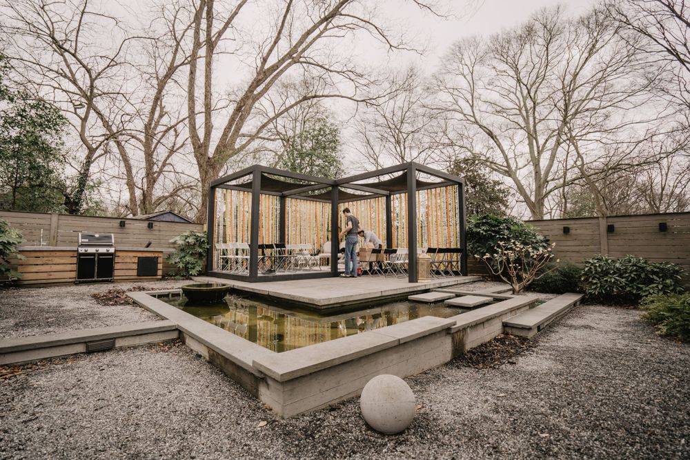 the back patio of the wedding venue, with a koi pond and pergola