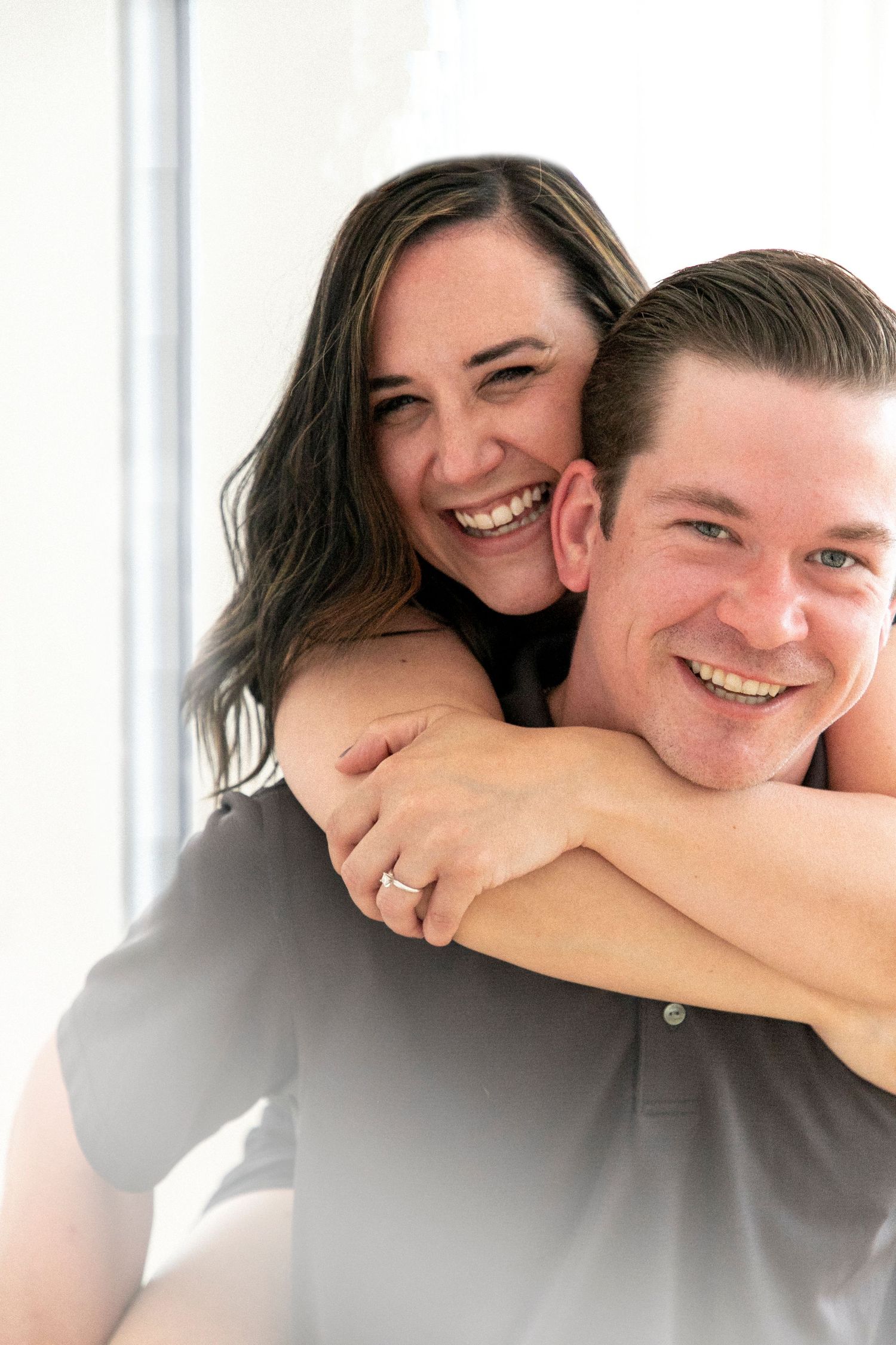 a woman piggybacking her fiance indoors. A close up shot.