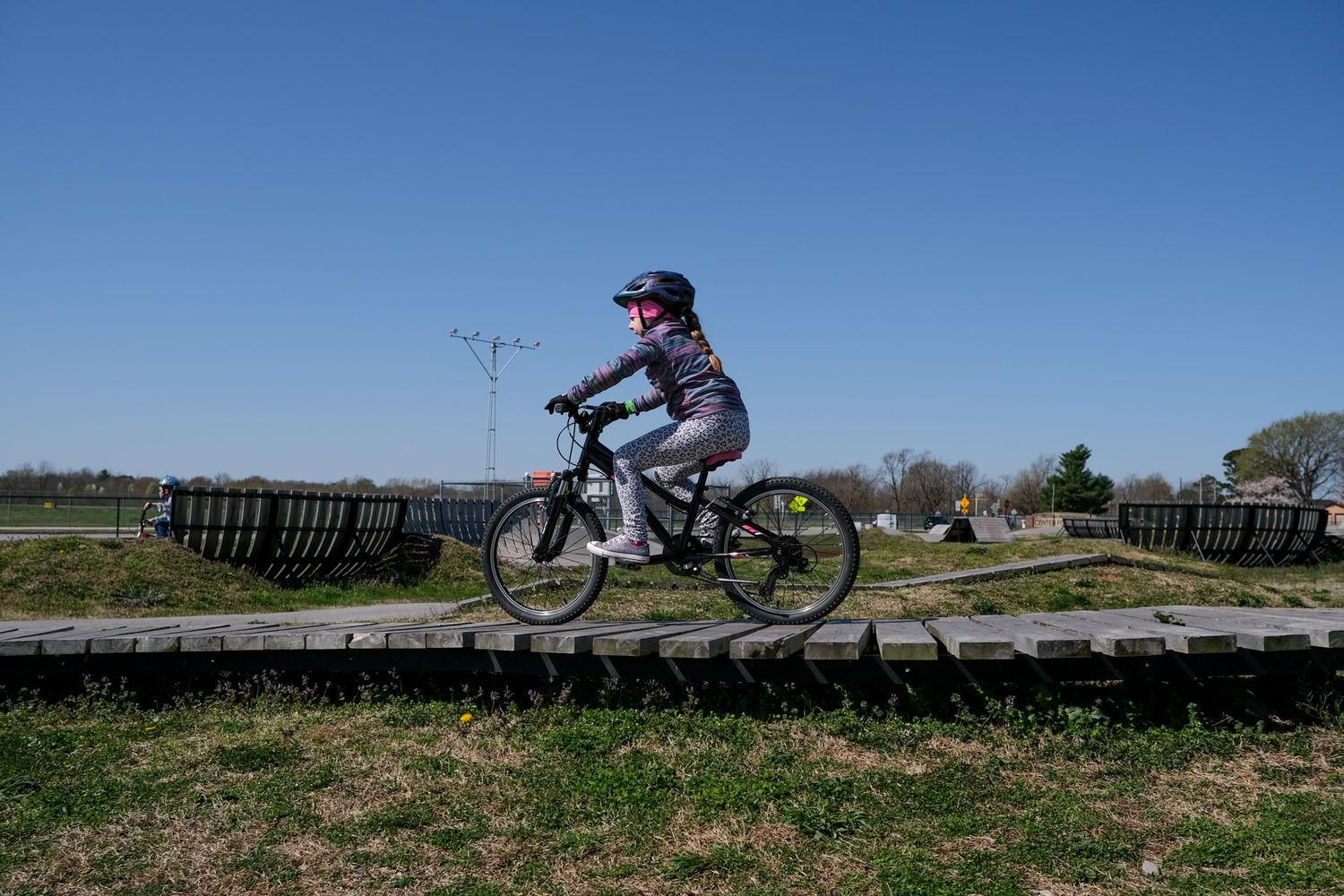 Girl on bike at Runway Bike Park for a family lifestyle photography session in Springdale, Arkansas.
