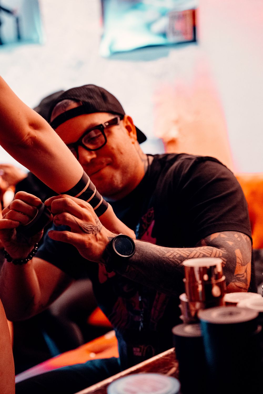 A series of cropped, artistic shots showing someone wearing a dark shirt working at a desk in warm lighting.