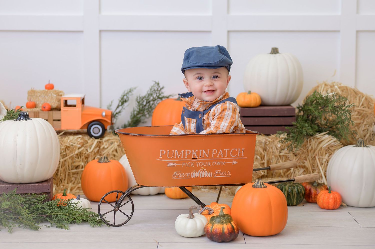baby boy in pumpkin patch wagon