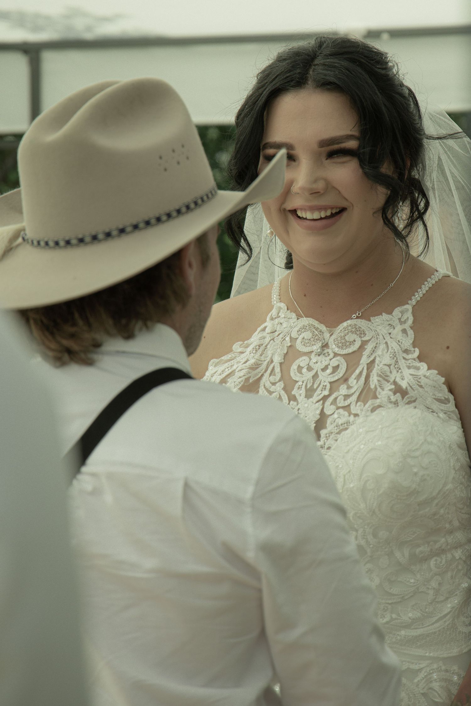 An intimate wedding portrait showing two people in vintage-inspired attire.