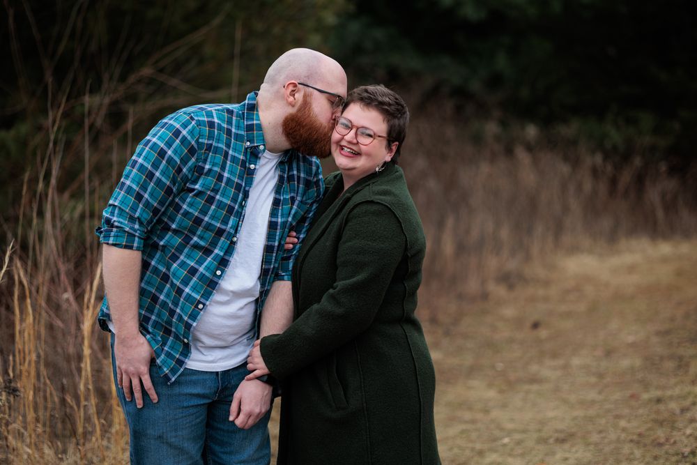 A couple shares a loving moment together during their outdoor photography session.