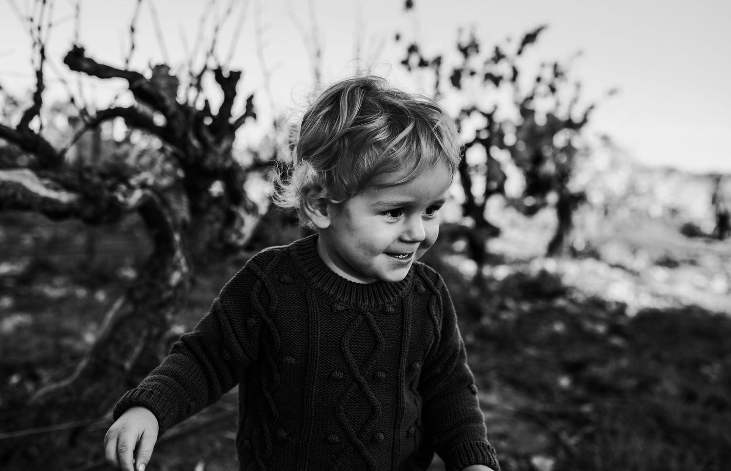 Black and white portrait series of a child exploring outdoors.