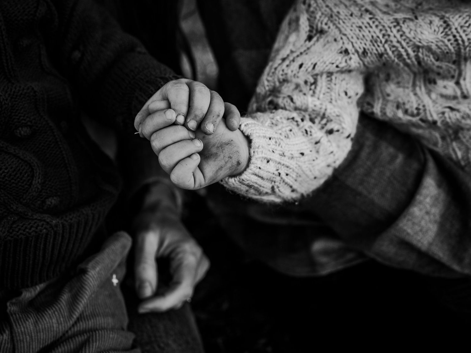 Black and white close-up shots of hands working with dough or bread.
