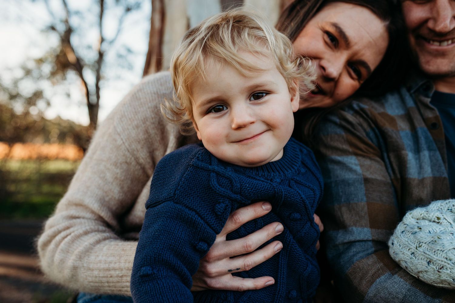 Candid family moments captured during fall photoshoot with warm lighting.