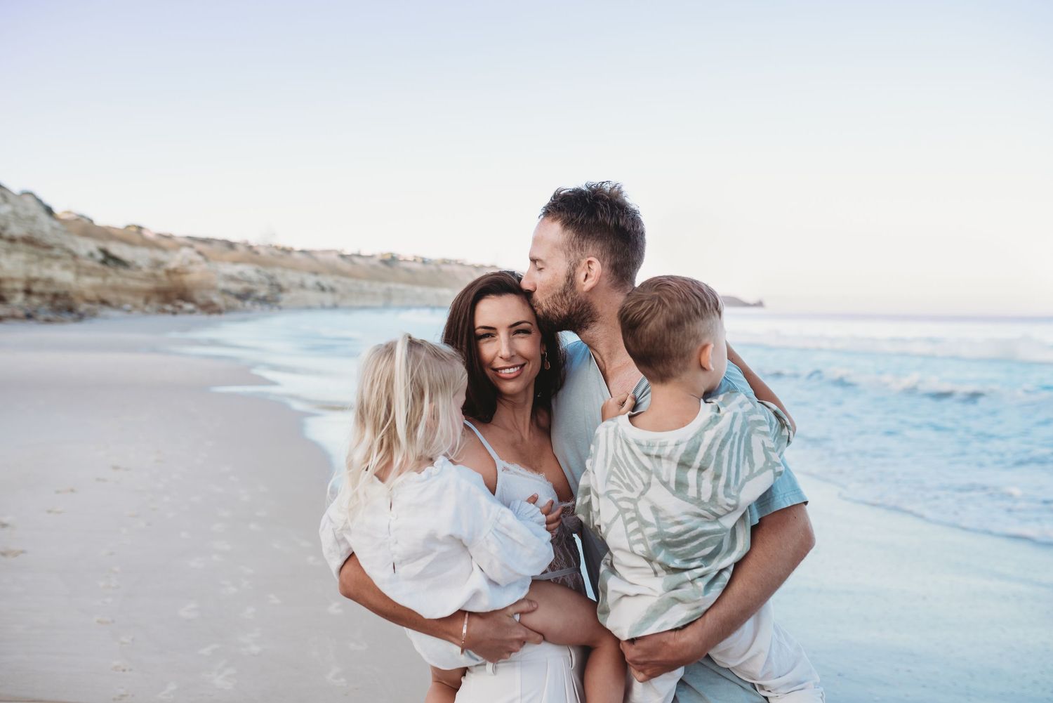 Romantic couple photography session at a scenic beach with soft lighting and natural poses.