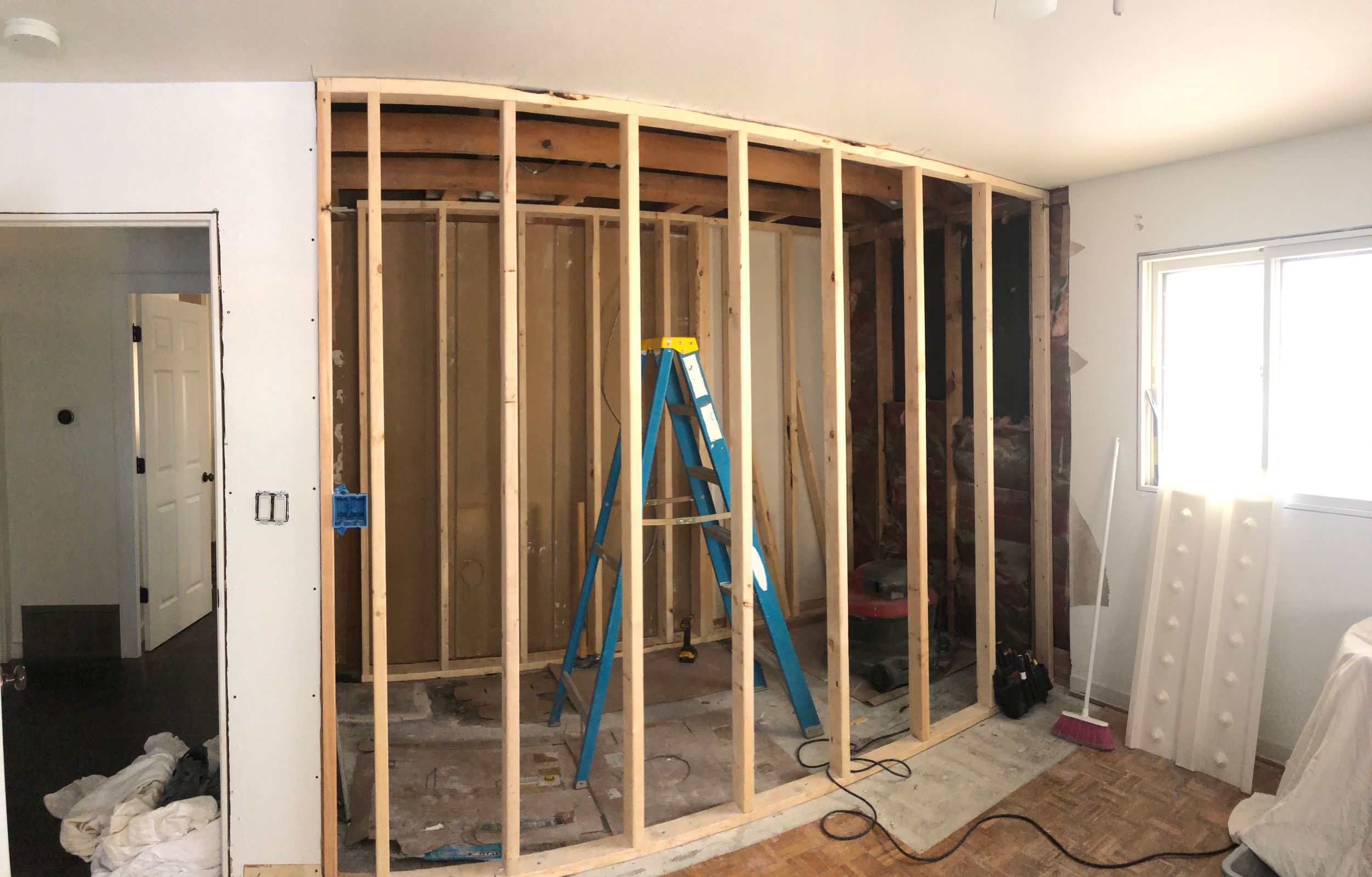 Construction progress photos showing framing and drywall installation in residential space.