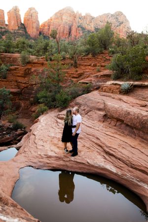 Sedona's stunning red rocks with a couple loving on each other near the seven sacred pools for their engagement photoshoot.