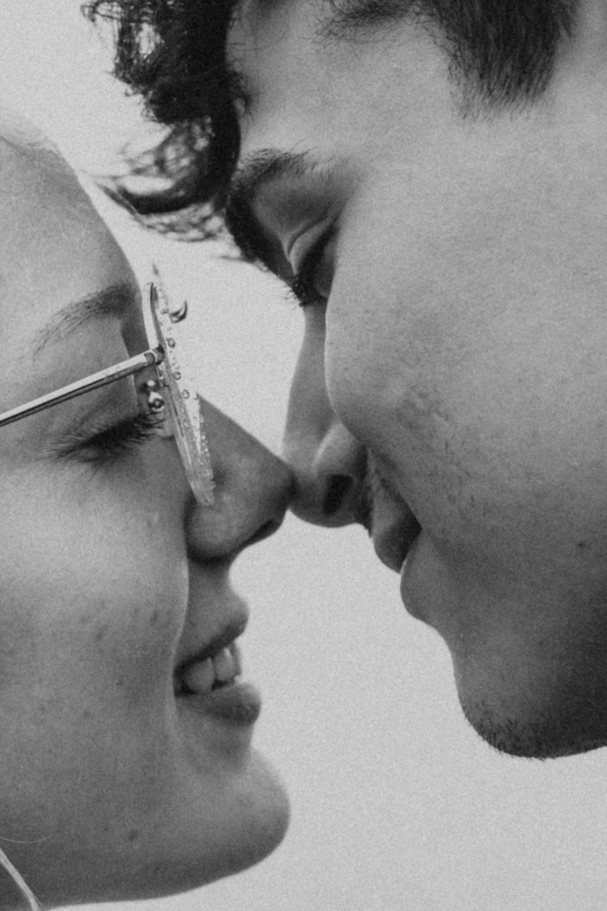 Close-up black and white photo of a smiling couple about to kiss during their Abbotsford engagement session.