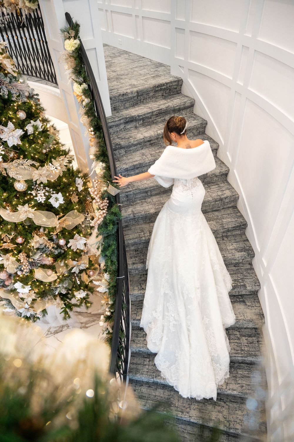 Bride ascending the stairs with her dress train on full display at Water's Edge