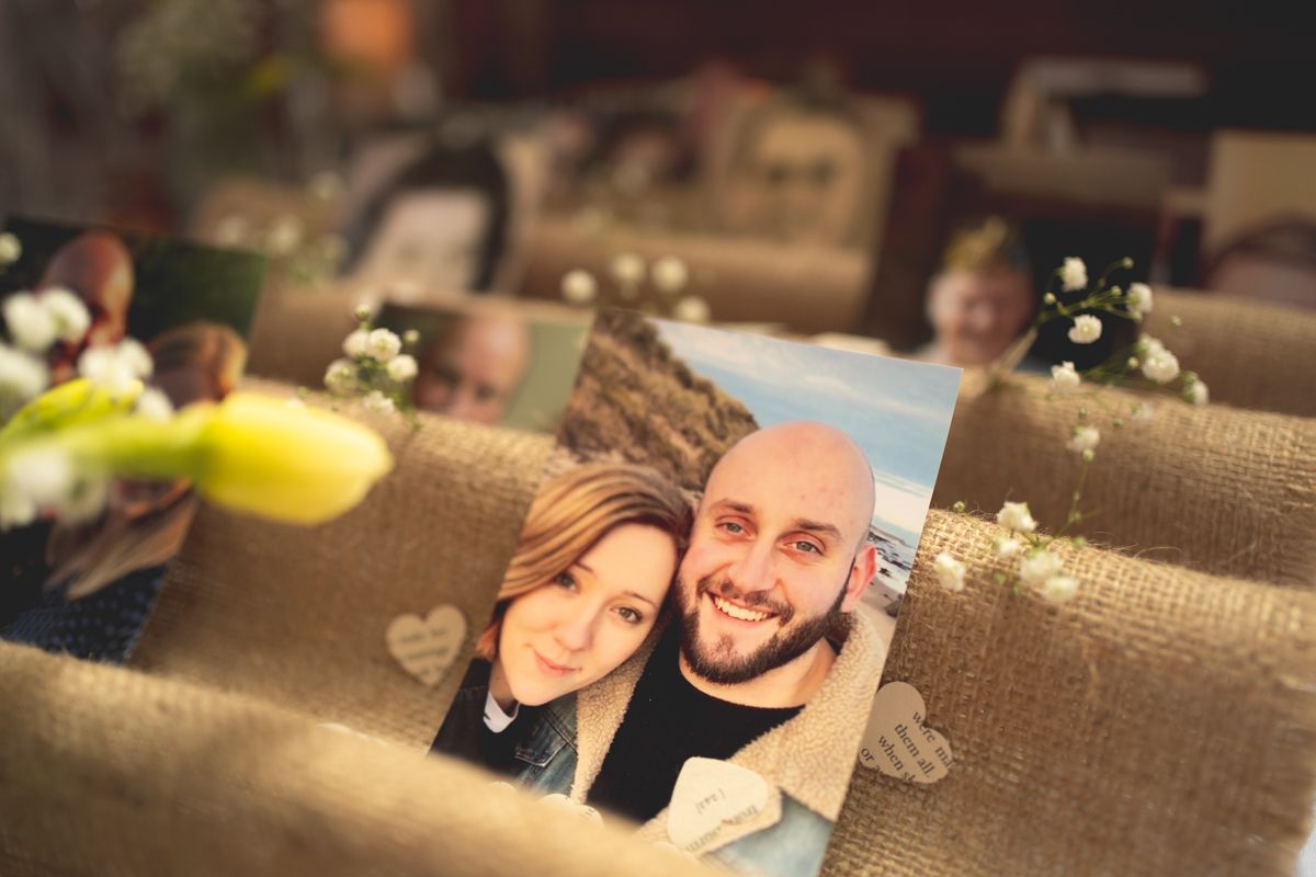 A romantic selfie photo displayed as a wedding table decoration with floral accents.