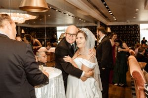 Reception celebration in an elegant venue with copper lighting fixtures.