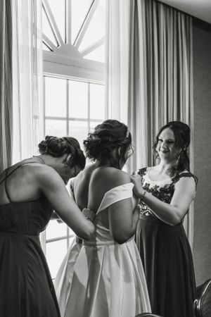 Black and white photo of getting ready preparations in a sunlit room.
