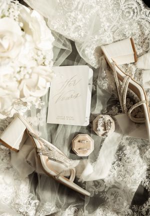 Wedding stationery and accessories styled with lace and floral elements.