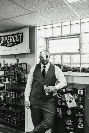 Interior of Uppercut hair salon with vintage industrial decor and product displays.