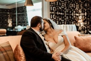 Intimate moment captured on a couch with modern decor.