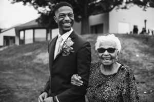 Black and white portrait of two people at an outdoor event.