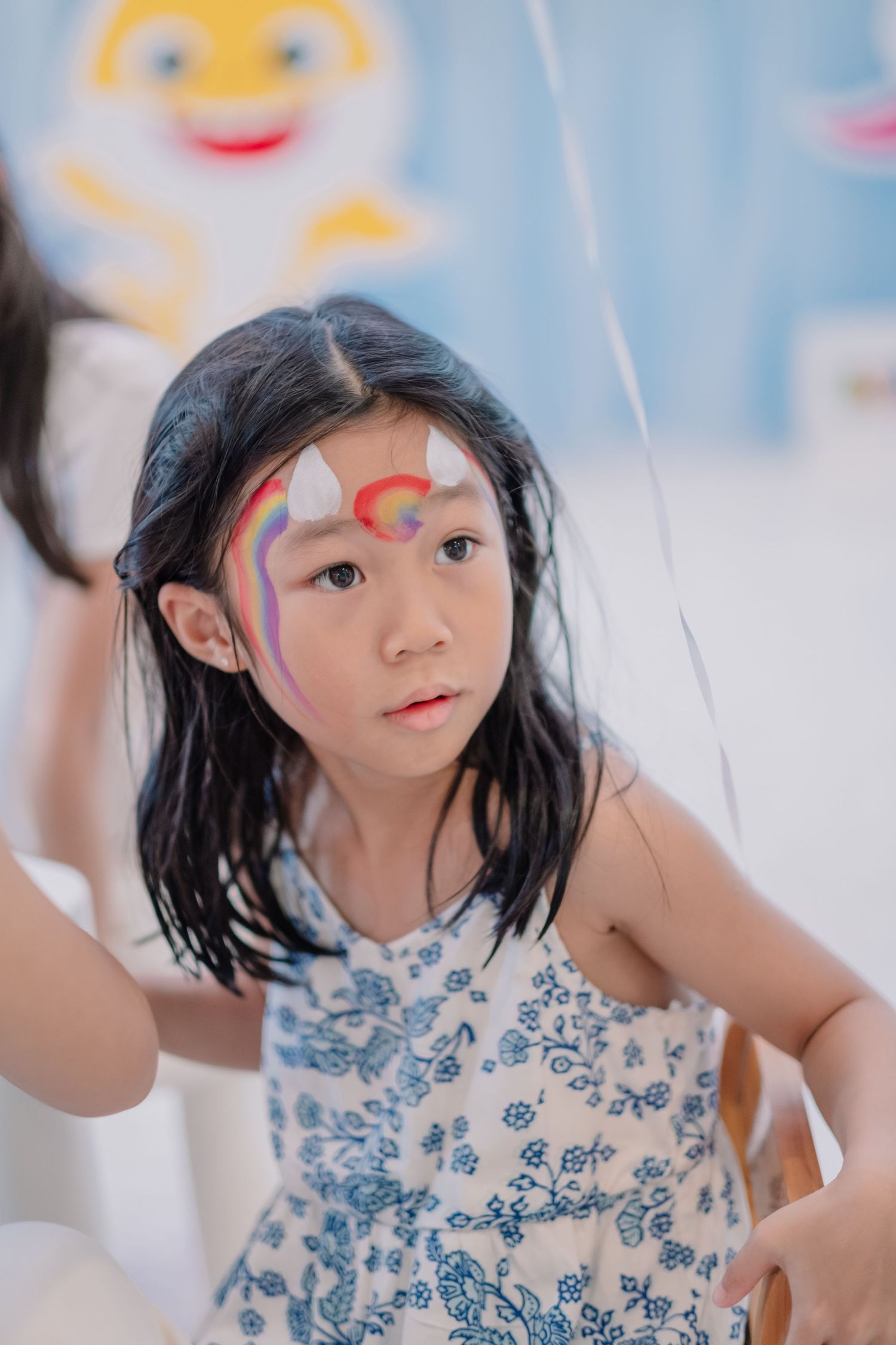 A festive party scene with face paint and decorative elements.