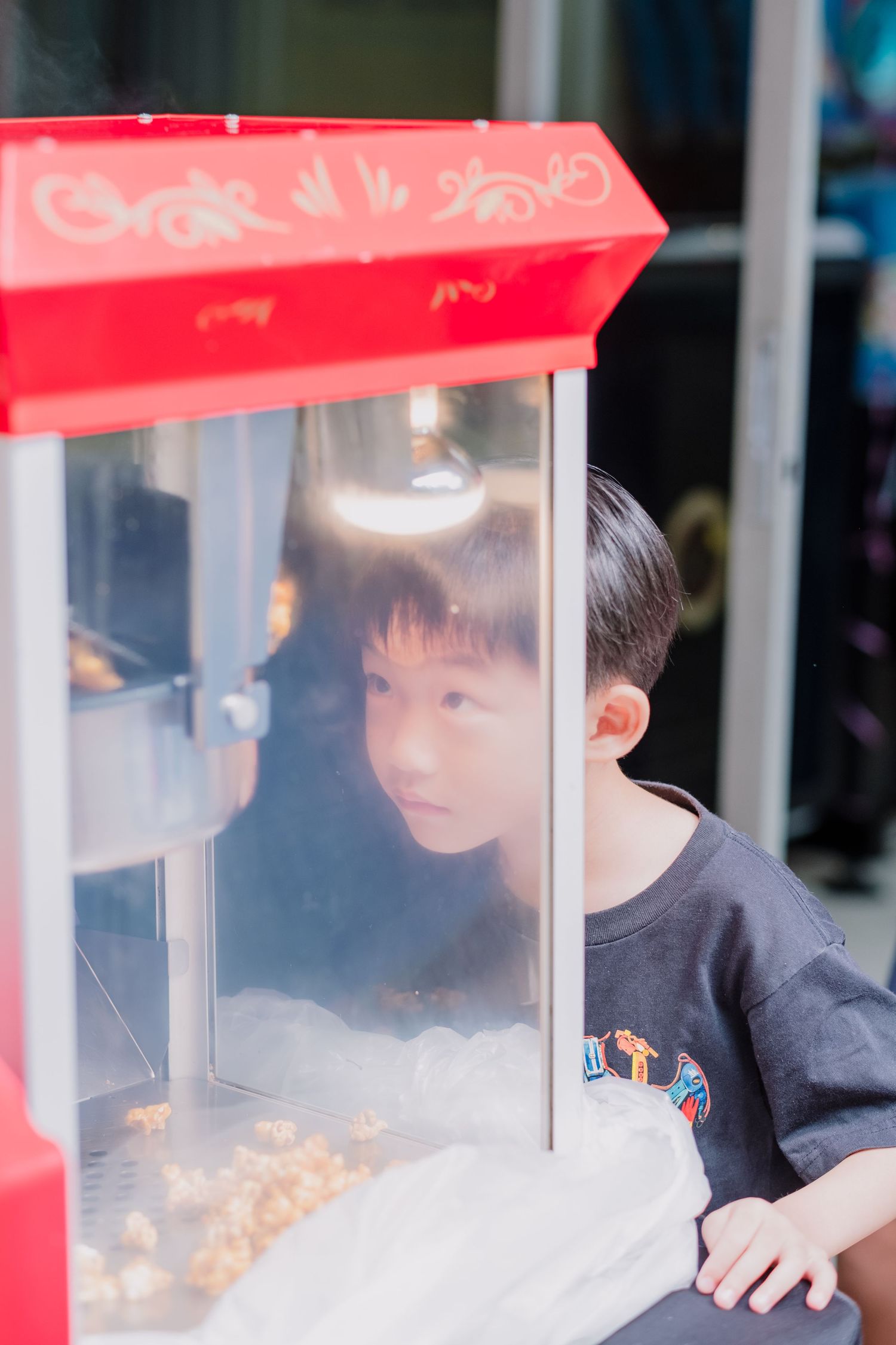 A popcorn machine being operated at an indoor event.