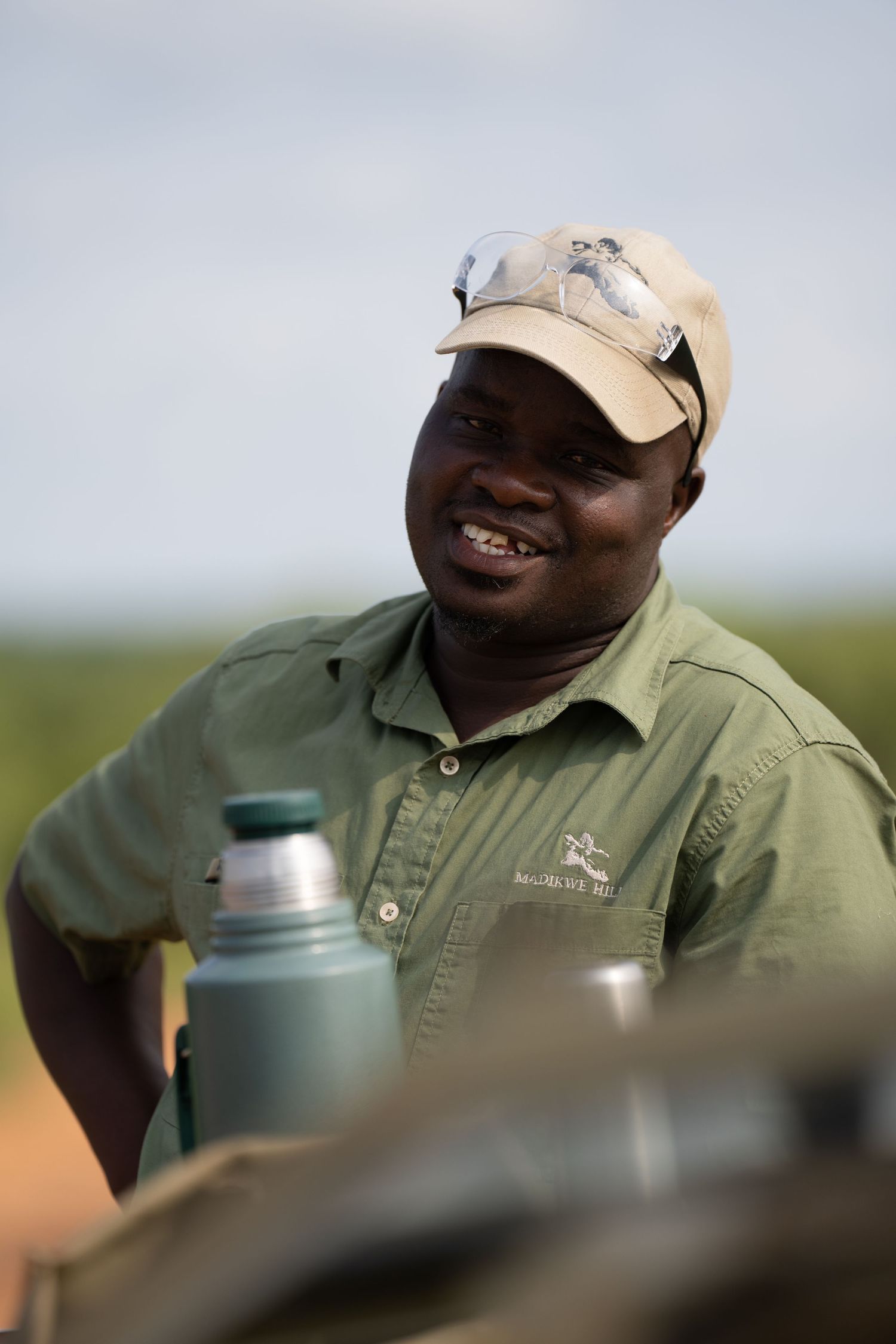 A series of candid shots showing a safari guide wearing a cap during an outdoor excursion.