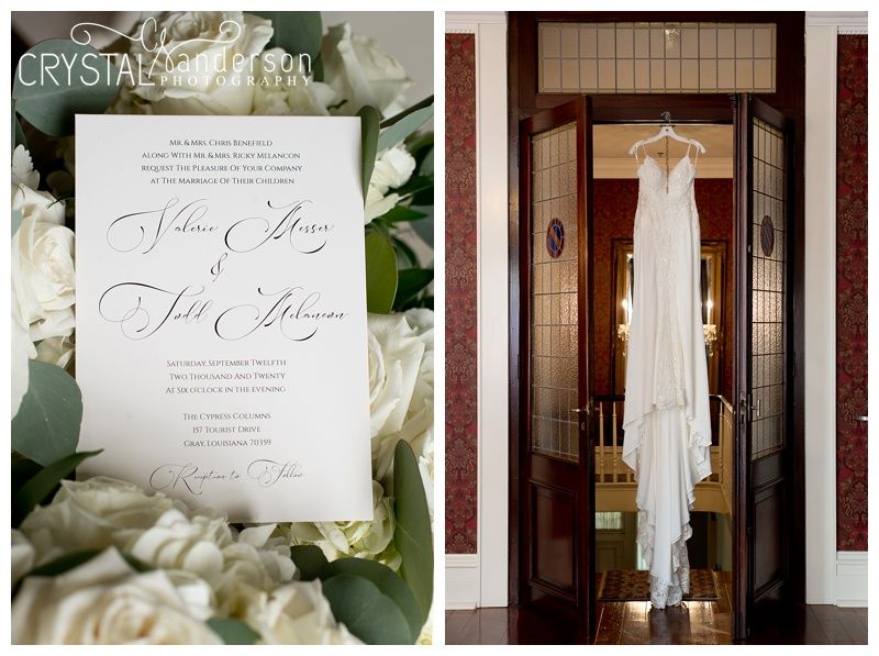 Wedding details including invitation, dress, and decor against wooden doors.