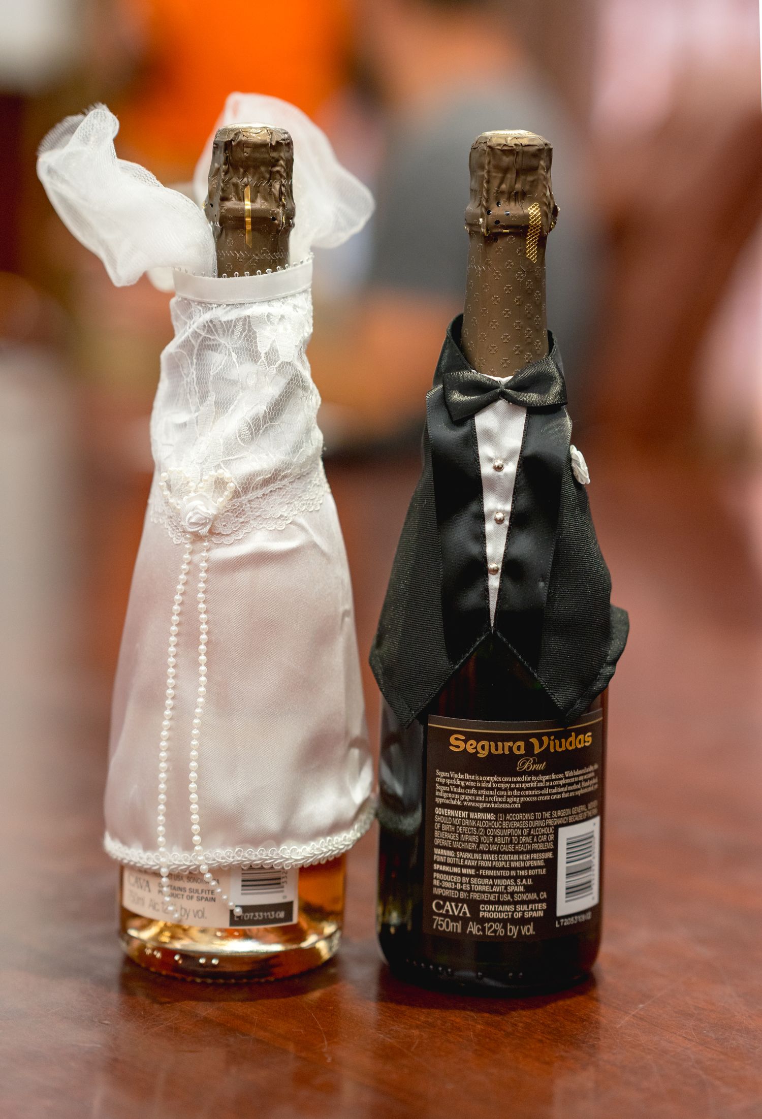 Elegantly adorned wine bottle covers for the bride and groom, adding a touch of charm to their special day.