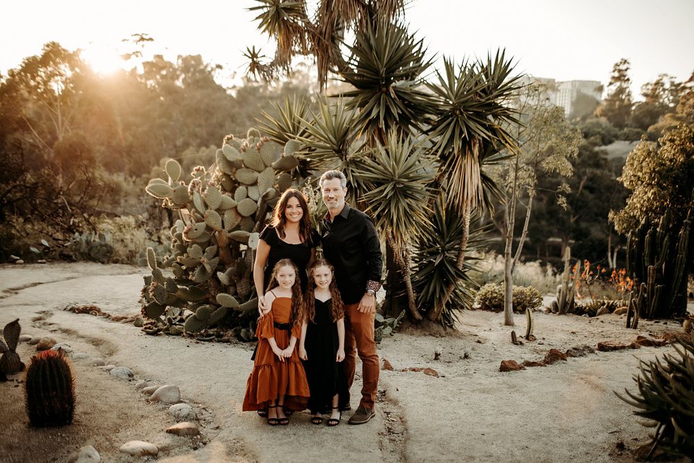parents and kids stand together during cactus garden family session