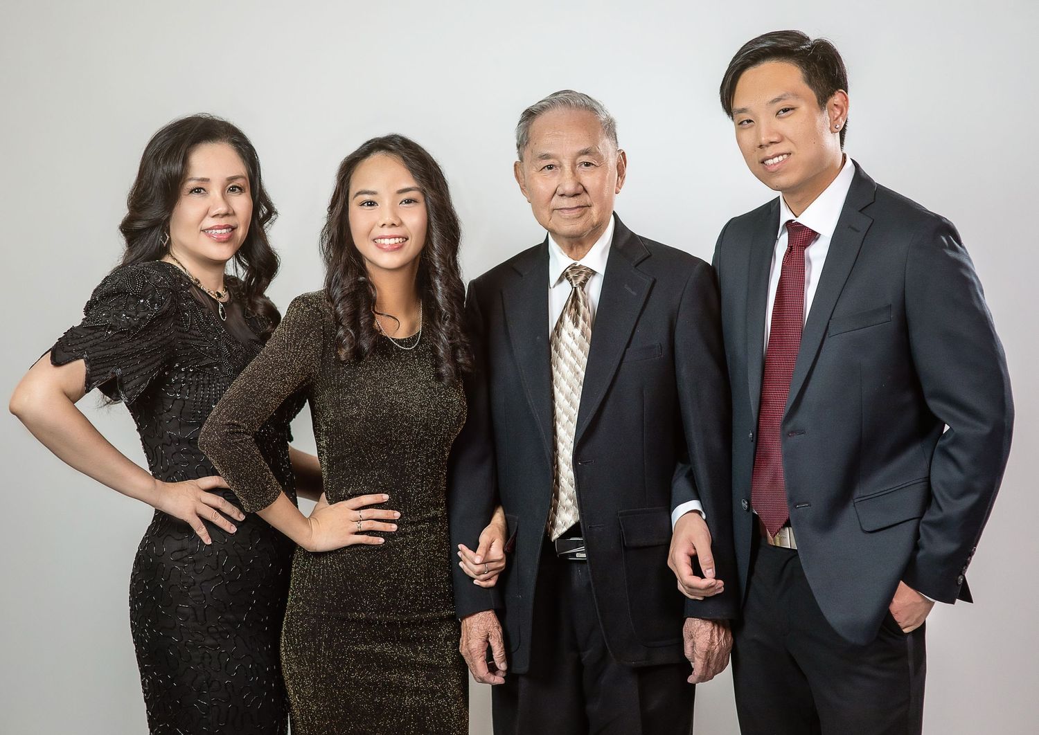 A professional family portrait against a white background.