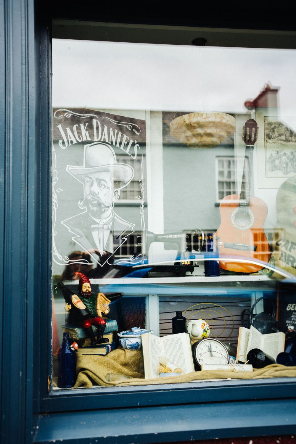 A shop window display featuring a Jack Daniel's logo and various vintage items.