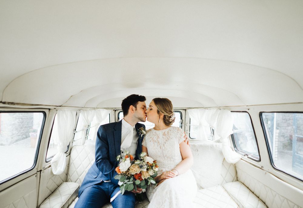 Intimate moment captured of newlyweds inside a vintage Volkswagen van.