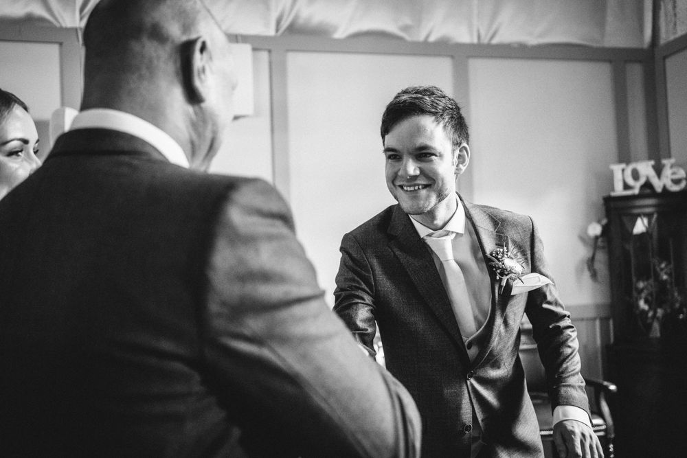 A couple exchanges vows during an intimate indoor wedding ceremony.