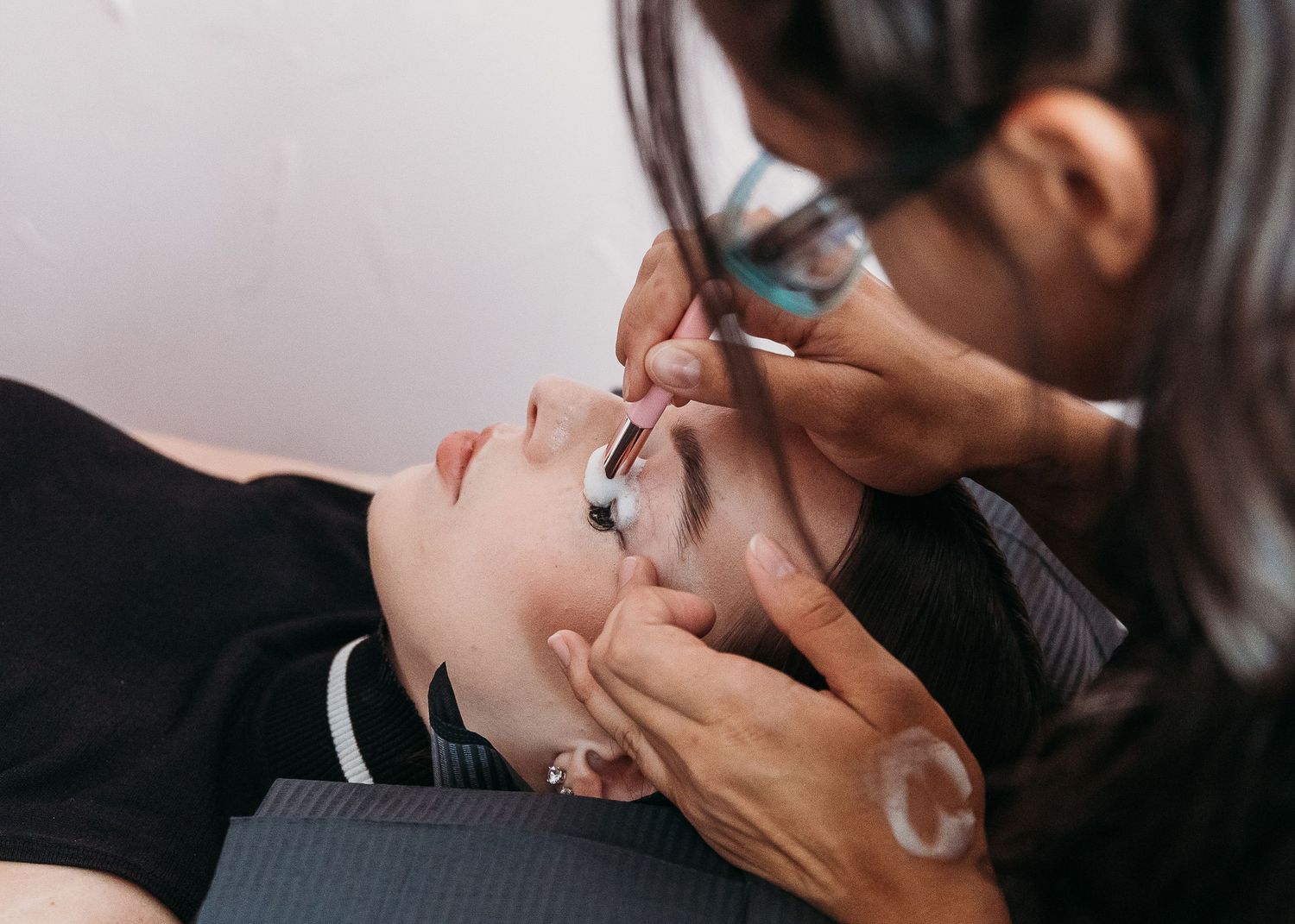 Professional beauty treatment being performed in a salon setting.