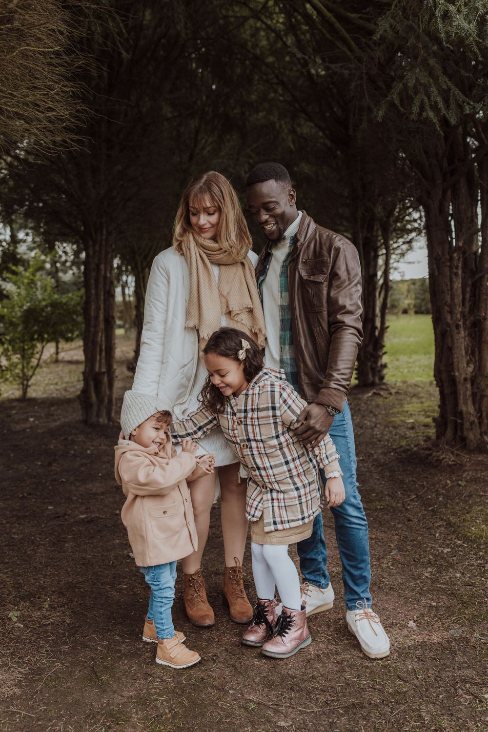 An intimate family moment shared between loved ones in a forest setting.