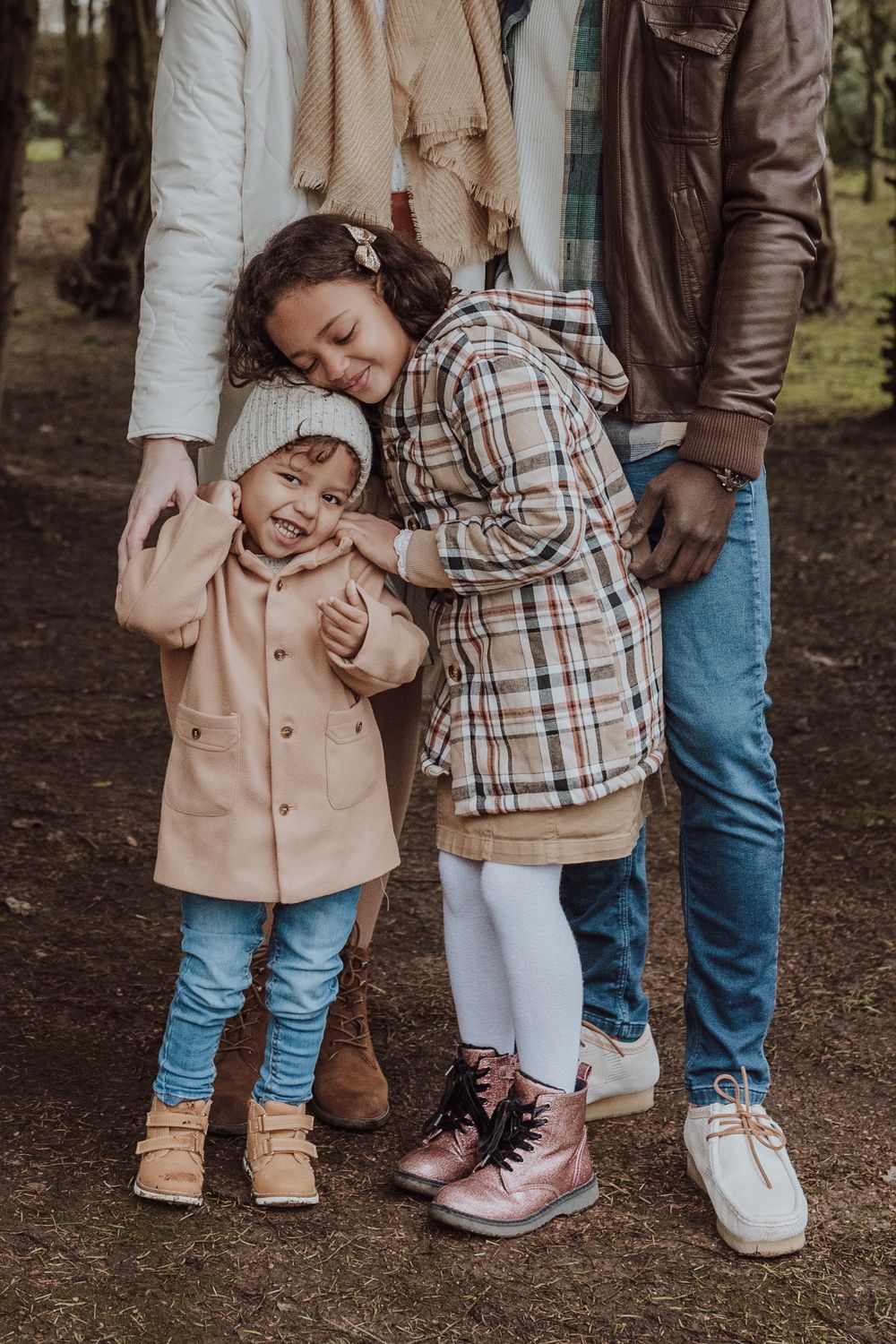 A close family portrait showing loving affection between family members in casual attire.