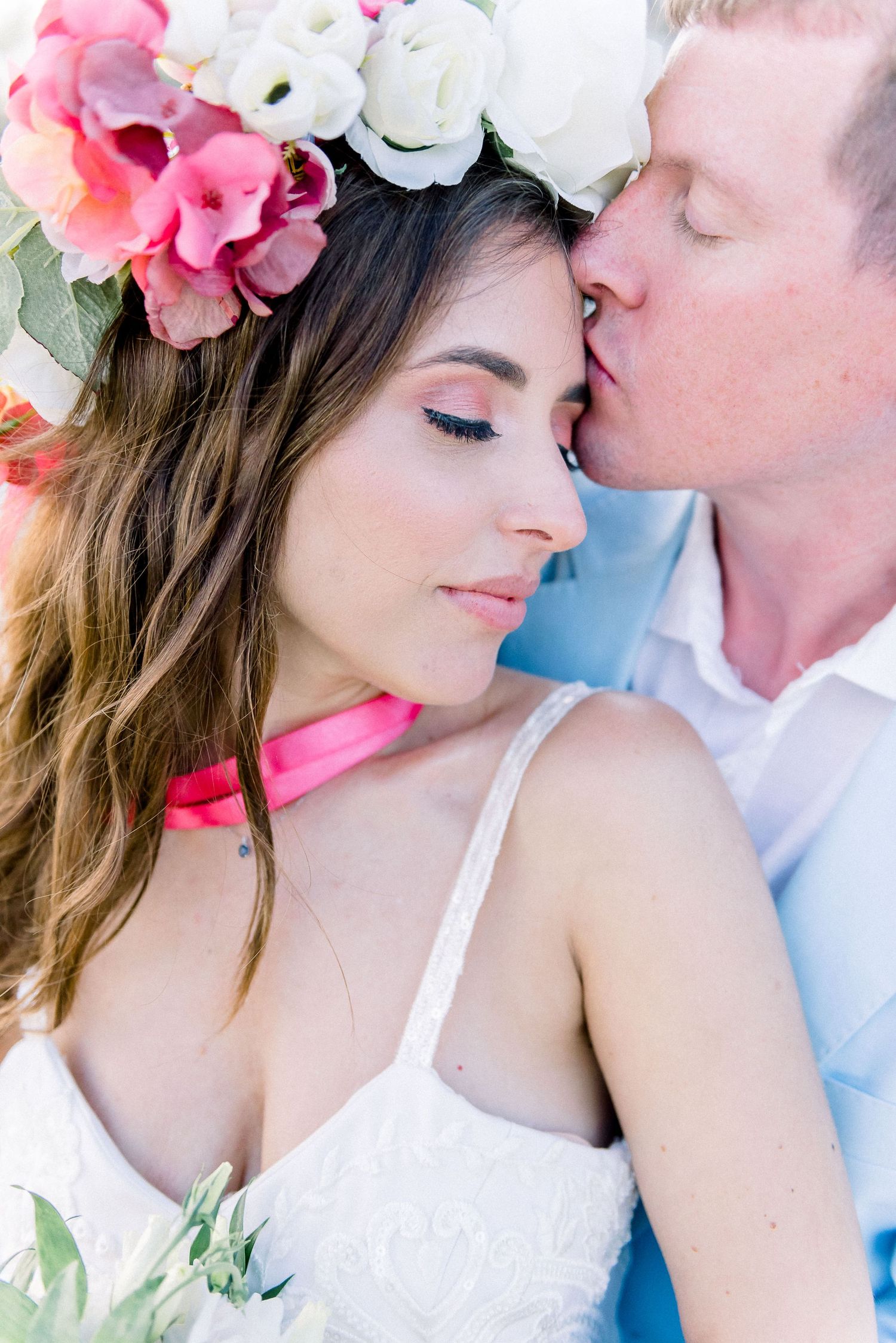 Romantic portrait of couple with floral crown in soft dreamy lighting.