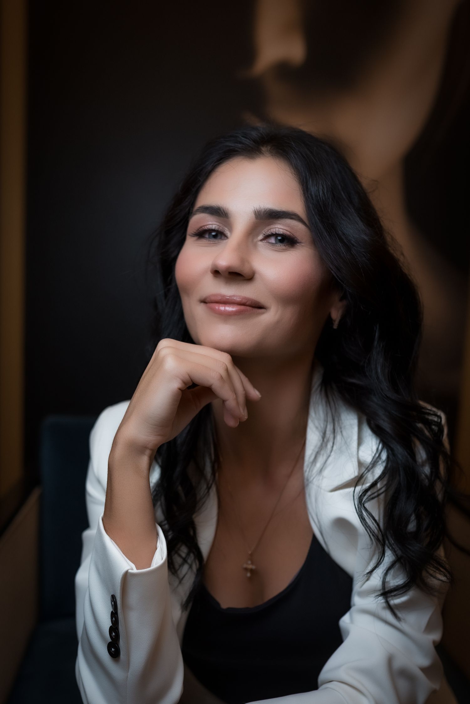 Intimate portrait series with white blazer in soft, natural lighting.
