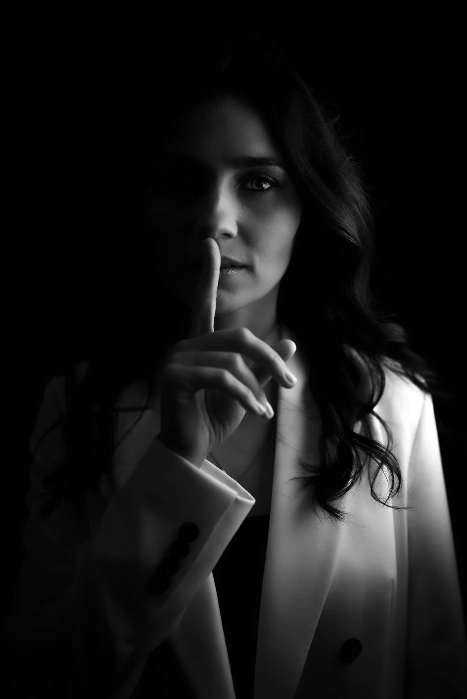 Dramatic black and white portrait series with moody lighting and shadows.