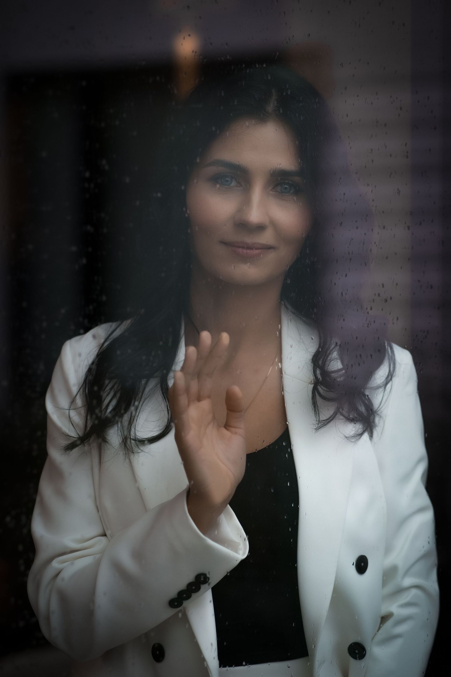 Soft focus portrait series featuring a white blazer against dark background.